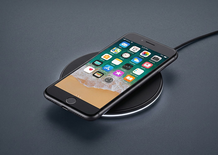 A black iPhone 8 sits on top of a wireless charger. 