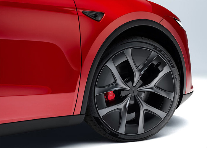 Close up of the a wheel and tire of a red Tesla Model Y juniper edition 