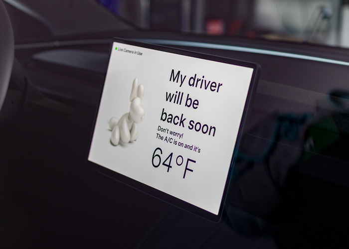 An interior of a Tesla dashboard screen showing the Dog Mode feature. 