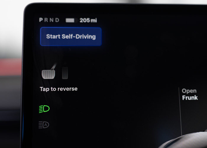 Interior view of a Tesla screen showing how to start the Full Self Drive FSD feature 