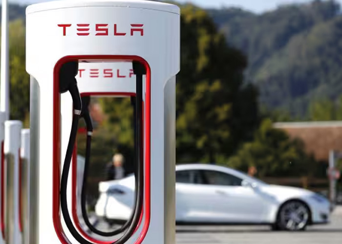 Outside view of a Tesla supercharger with a mountain scape in the background