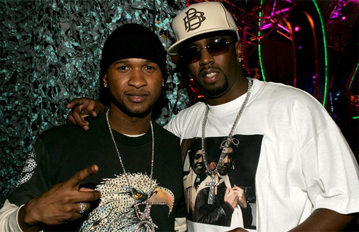 usher and Diddy embrace in a early 2000's photograph at an event 